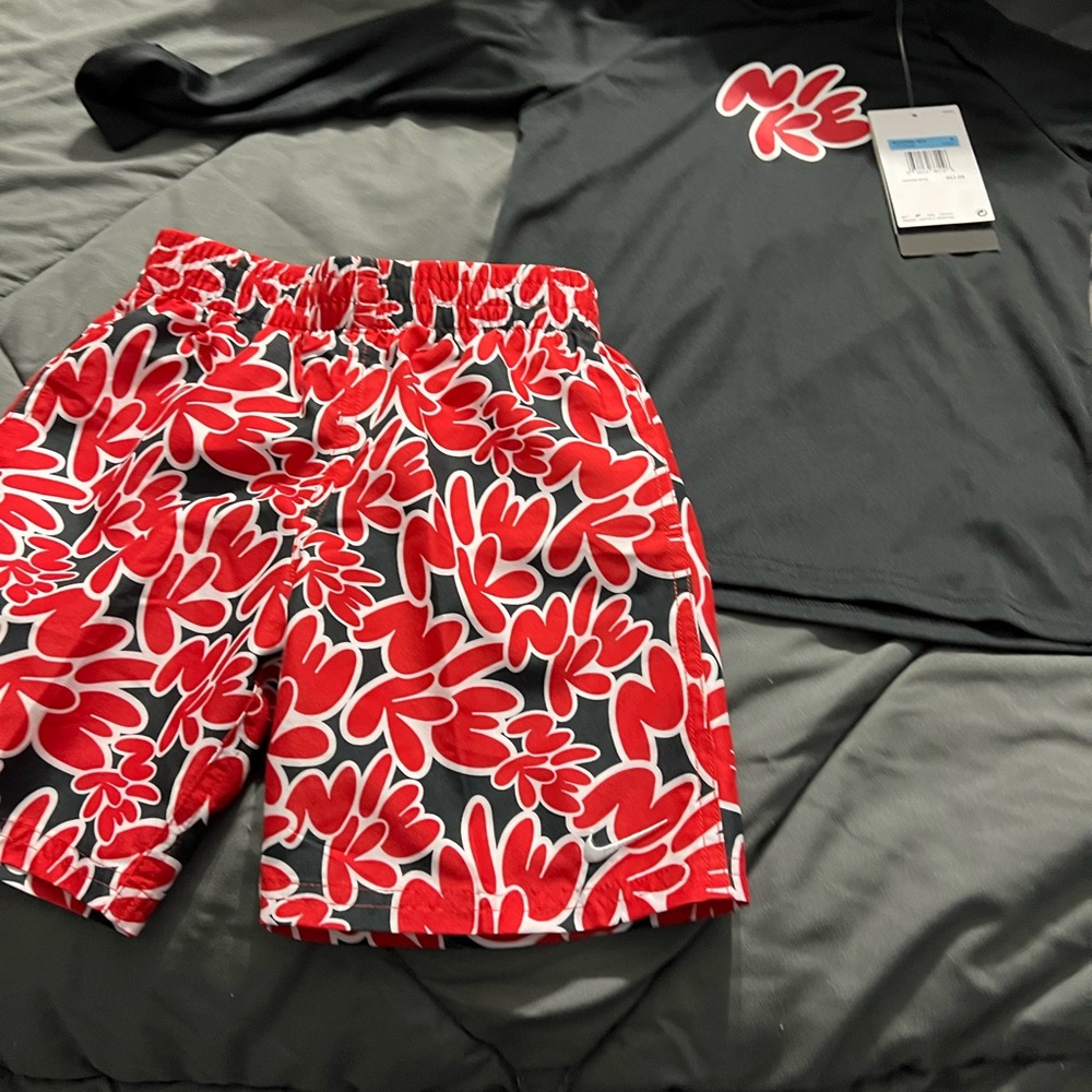 New with tags Nike Kids Red and Black  Swim set trunks and rash guard.